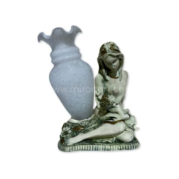 A handcrafted mother-child figurine in soft gray tones appears against a white background, emphasizing its form and gentle design.
