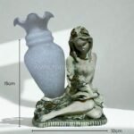 A handcrafted mother-child figurine in soft gray tones appears against a white background, showcasing its gentle design and compact size at 10 cm x 15 cm.