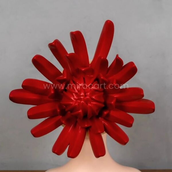 Detail view of the resin sculpture’s bold flame crown in red and yellow.