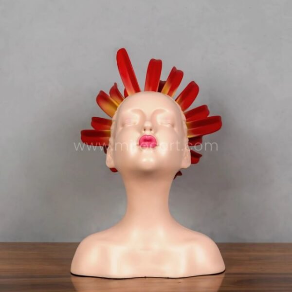 Angled look at the sculpture’s playful kissy face and flaming crown.