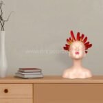 Innocent Flame Resin Sculpture perched beside books and a vase, styling a modern shelf.