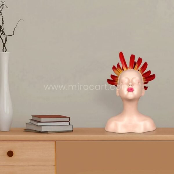 Innocent Flame Resin Sculpture perched beside books and a vase, styling a modern shelf.
