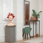 Resin sculpture glowing from a pedestal in a dramatic entryway.