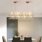 Gold bar chandelier chandelier with cascading crystals in a minimalist dining space.
