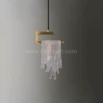 The Flowing Waterfall Pendant Light shines against a muted gray backdrop, its gold and crystal details popping with quiet confidence.