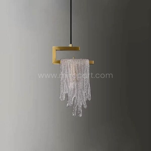 The Flowing Waterfall Pendant Light shines against a muted gray backdrop, its gold and crystal details popping with quiet confidence.