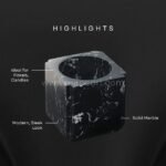 Close-up details of a black marble vase showing its glossy finish, unique veining, and sturdy geometric shape.