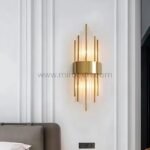 Modern Cascade Wall Light above a bed, softly lighting a modern bedroom.