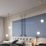 Gold modern arc pendant lights in a tranquil blue-gray bedroom.