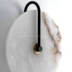 Close-up of Moonlit Alabaster Wall Light showing gold frame, veining, and smooth alabaster surface.