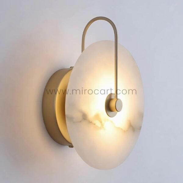 Sleek Moonlit Alabaster Wall Light with minimalist gold detailing on a plain white wall.
