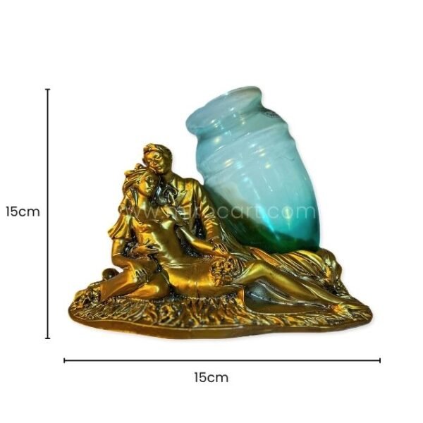 Gold-toned sculpted lovers figurine with opaline glass vase shown next to a ruler indicating 15cm x 15cm.