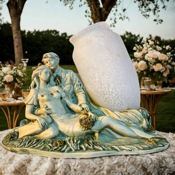 Sculpted lovers figurine with opaline glass vase placed on a stone garden table surrounded by blooming flowers and greenery.