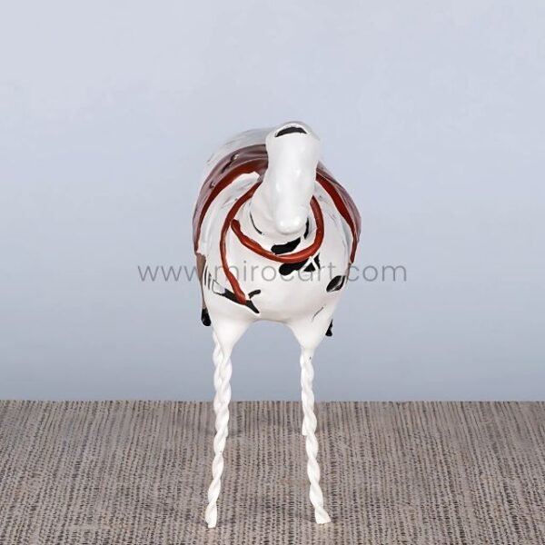 Frontal view of Shattered Ride sculpture highlighting its twisted legs and expressive stance.