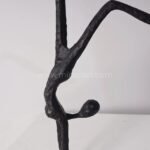 Extreme close-up of the Stillness in Motion Sculpture, showcasing its textured surface and the delicate interplay of lines and curves.