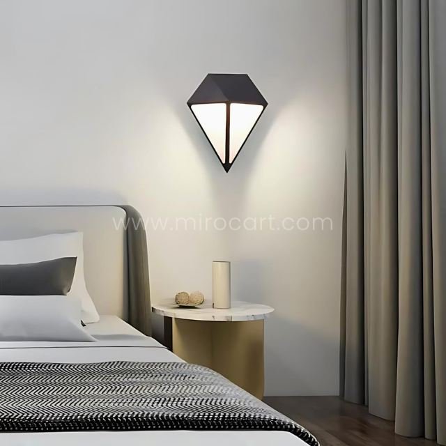 Diamond wall light above a bed, providing soft warm white LED illumination in a calm and cozy bedroom setting.