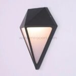 Detailed close-up of black diamond wall light showcasing sharp angles and warm diffused LED illumination.