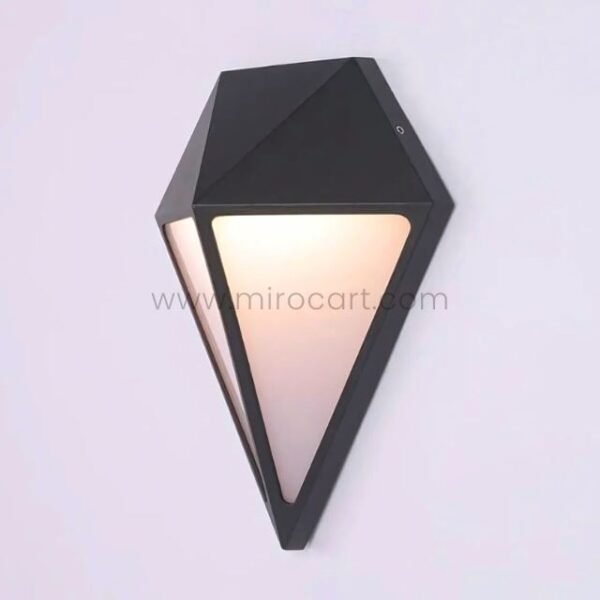 Detailed close-up of black diamond wall light showcasing sharp angles and warm diffused LED illumination.