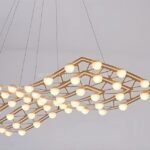 Modern flowing gold chandelier with a lattice-like structure, creating a sculptural glow.