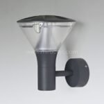 Close-up of modern outdoor wall light with smooth black finish and compact structure.