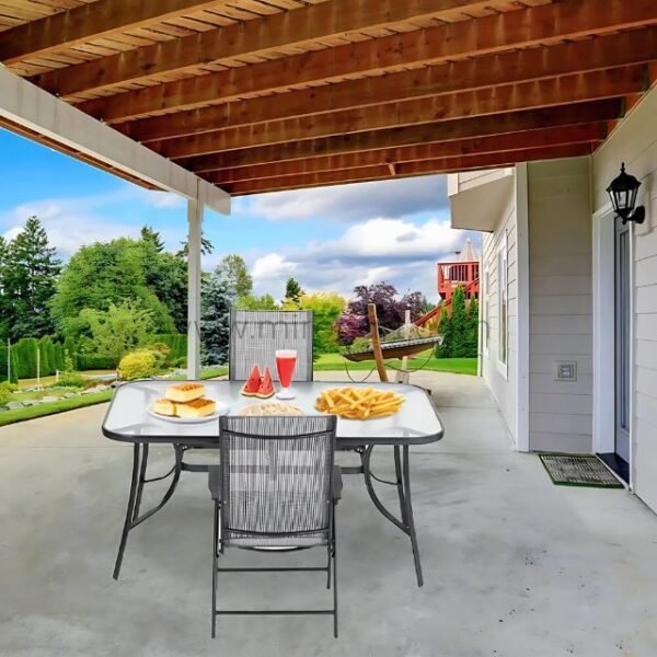 Modern outdoor table set with glass top and foldable chairs under a wooden pergola.