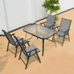 Compact modern outdoor table set with glass top and foldable chairs for small spaces.