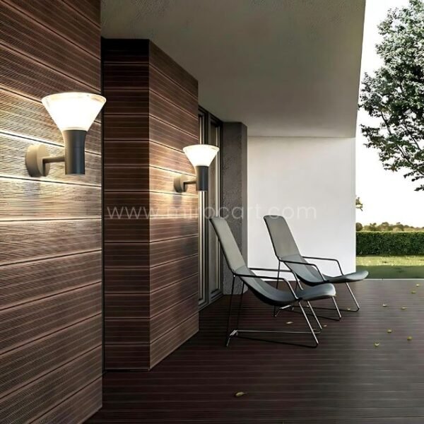 Modern outdoor wall lights mounted on a deck wall, casting ambient light across a cozy outdoor area.