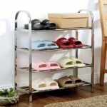 Premium stainless steel shoe rack styled with colorful slippers and a shoebox in a cozy space.