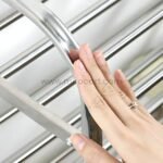 Hand touching the smooth surface of the premium stainless steel shoe rack.