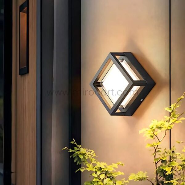 Modern sleek cube wall light with 3000K warm LED glow on exterior wall.