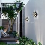 Outdoor lounge with sleek cube wall lights creating warm ambient lighting.