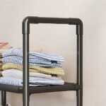 Spacious multi-shelf shoe organizer used creatively to store folded clothes on one of its wide shelves.