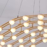 Circular flowing gold chandelier design, its interconnected loops radiating a warm glow.