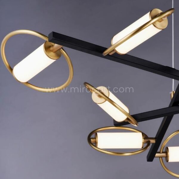 Close-up of Modern Cross Pendant Chandelier showing black frame, gold rings, and glowing opal acrylic tubes.