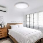 Sleek LED ceiling downlight casting soft light over a minimalist bedroom.